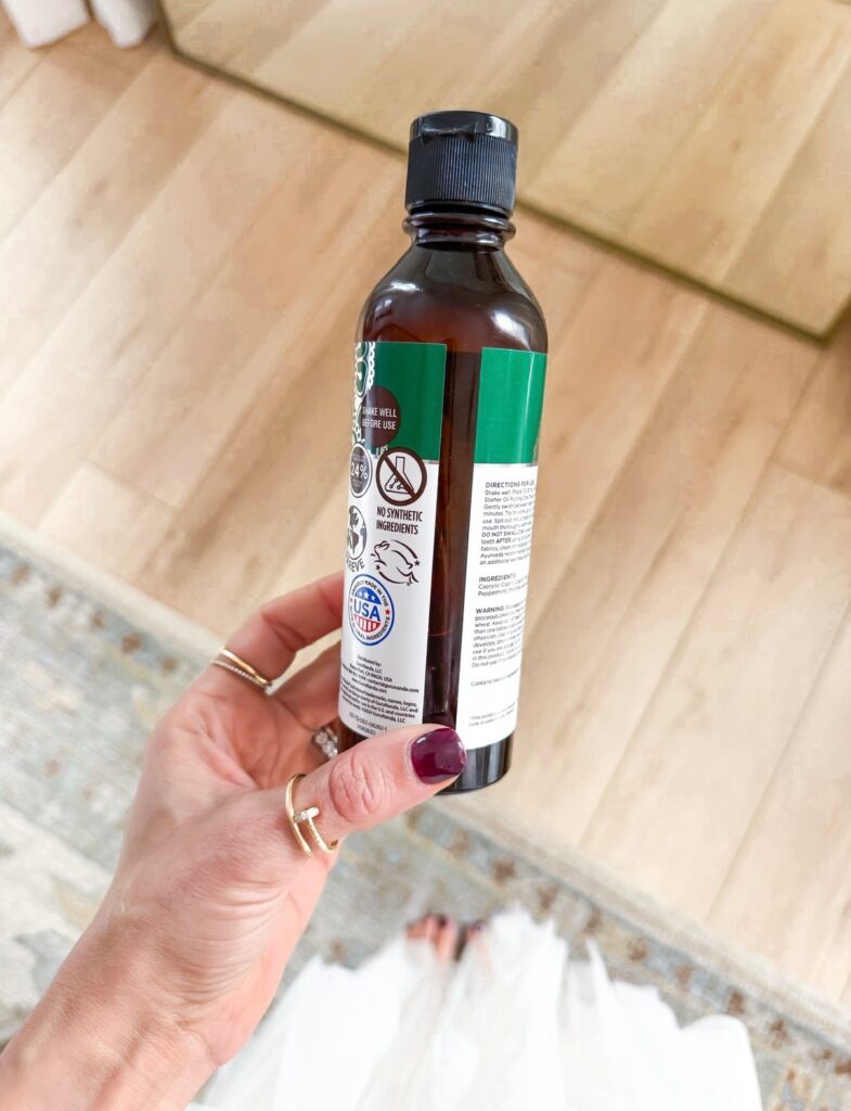 Close up of oil pulling mouthwash bottle as part of unsexy self-care things