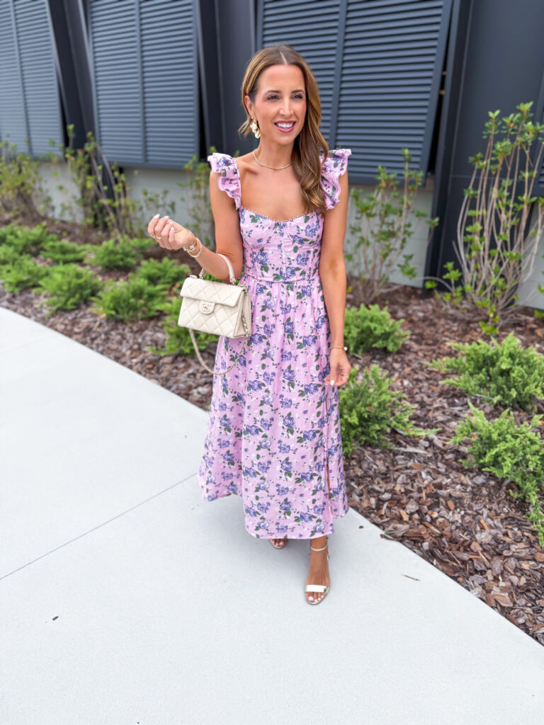 woman in pink and purple flutter sleeve floral midi dress as wedding guest dress