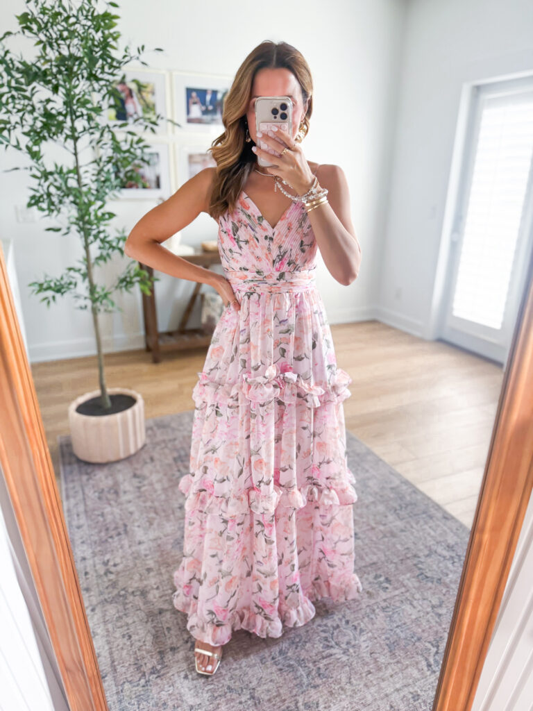 woman wearing pink floral maxi dress for a spring wedding
