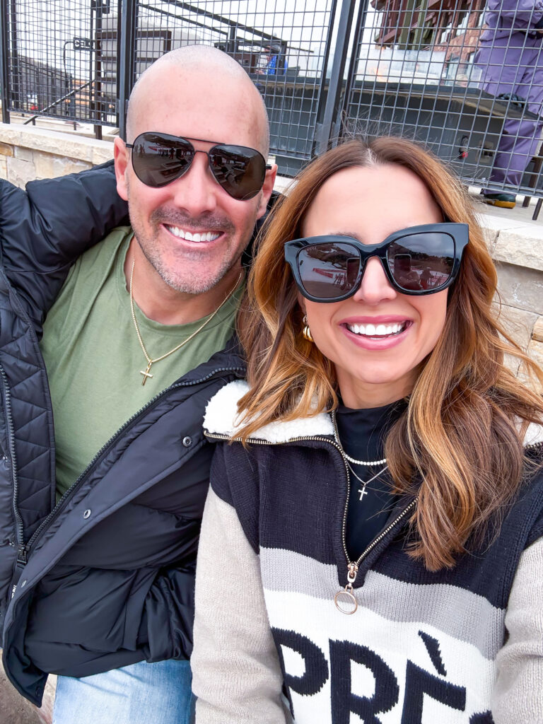 Couple smiling in Park City, Utah while waiting for children taking ski lessons
