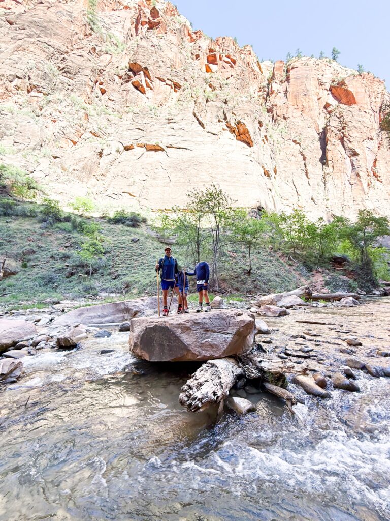 Father and sons posing while hiking at Temple of Sinawava at Zion