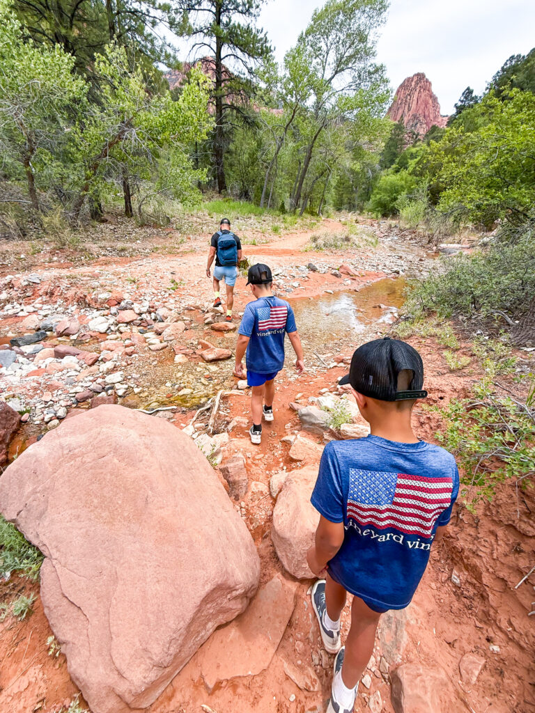 Father and sons walking through the creeks at Taylor Creek Trailhead in Zion