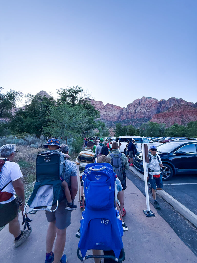 People waiting in line for a shuttle that takes you into the Narrows in Zion