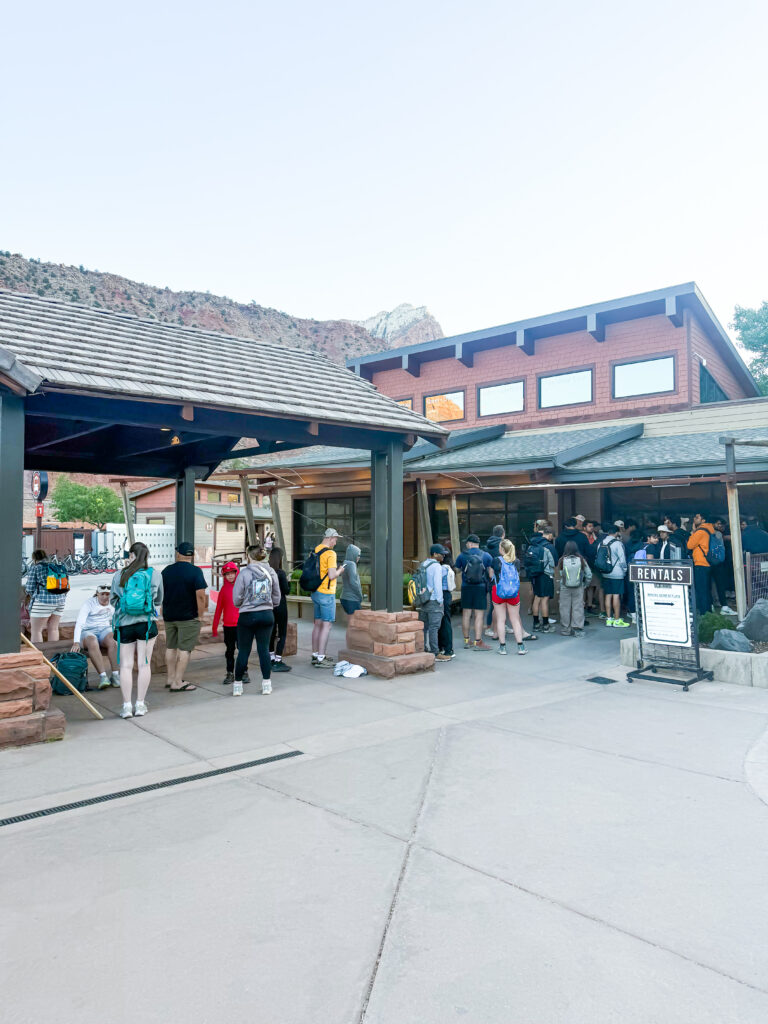 Line of people waiting to get into Zion Outfitters for rental gear