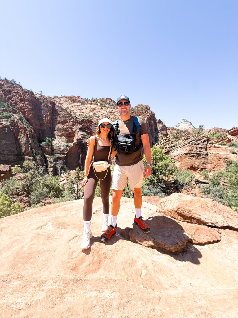 Couple posing for picture at top of Canton Overlook Trail in Zion
