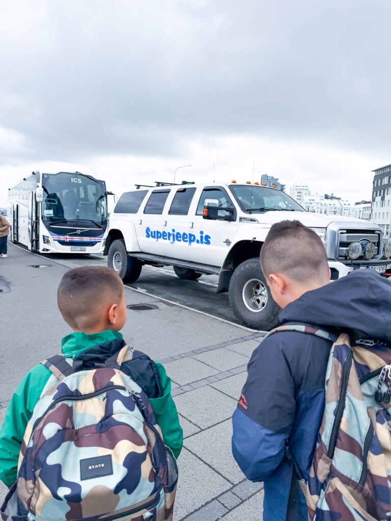 Kids looking at Superjeep in Iceland